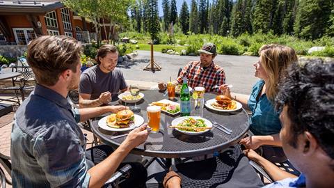Friends dining on the patio at Honeycomb Grill at Solitude Mountain Resort