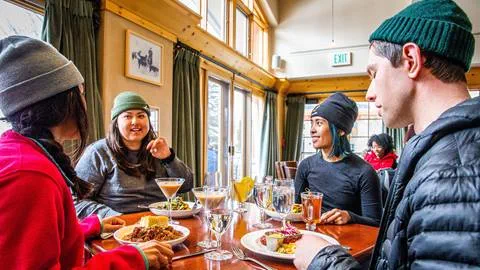 Four friends enjoying a meal at St. Bernard's at Solitude Mountain Resort