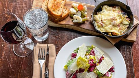 Salad and appetizer at St. Bernard's with a glass of wine