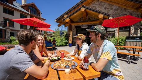 Friends enjoying pizza at Stone Haus at Solitude Mountain Resort