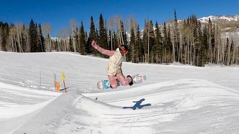 Female rider hitting a jump in the Solitude Terrain Park