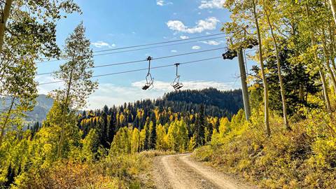 Scenic fall chairlift ride with colorful aspen leaves at Solitude Mountain Resort