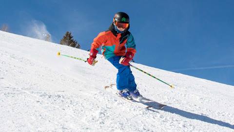 A skier with the Big Mountain Team at Solitude Mountain Resort carves a turn